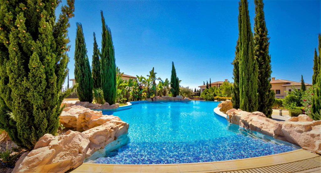 View of Alexander Heights Village communal pool on Aphrodite Hills Resort, Cyprus, with sea views.