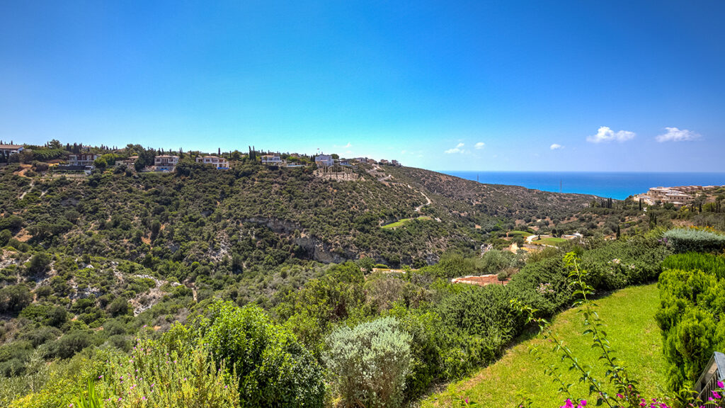 View from Apartment U2 on Aphrodite Hills, Adonis Village, Cyprus. Looking down grassy ravine out to sea. Presented by Aphroditerentals.com