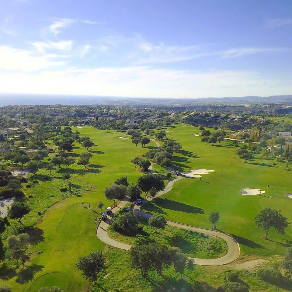 Aerial view of the 3rd and 4th holes at Aphrodite Hills Golf Course, looking out to the Cypriot coastline and Mediterranean Sea.