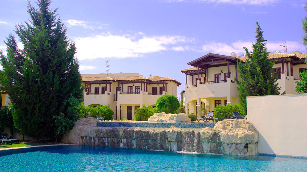 View of apartment blocks overlooking the pool at Helios Heights, Aphrodite Hills Resort. Presented by Aphroditerentals.com