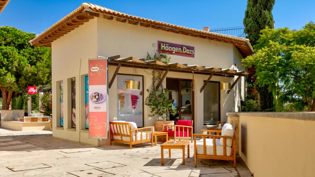 View of the Haagen Dazs cafe at Aphrodite Hills Resort, with comfortable seating outside. Cyprus.