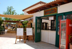 Ladi and Rigani Kebab shop front on Aphrodite Hills - showing ordering counter, menu boards and tables in the background.