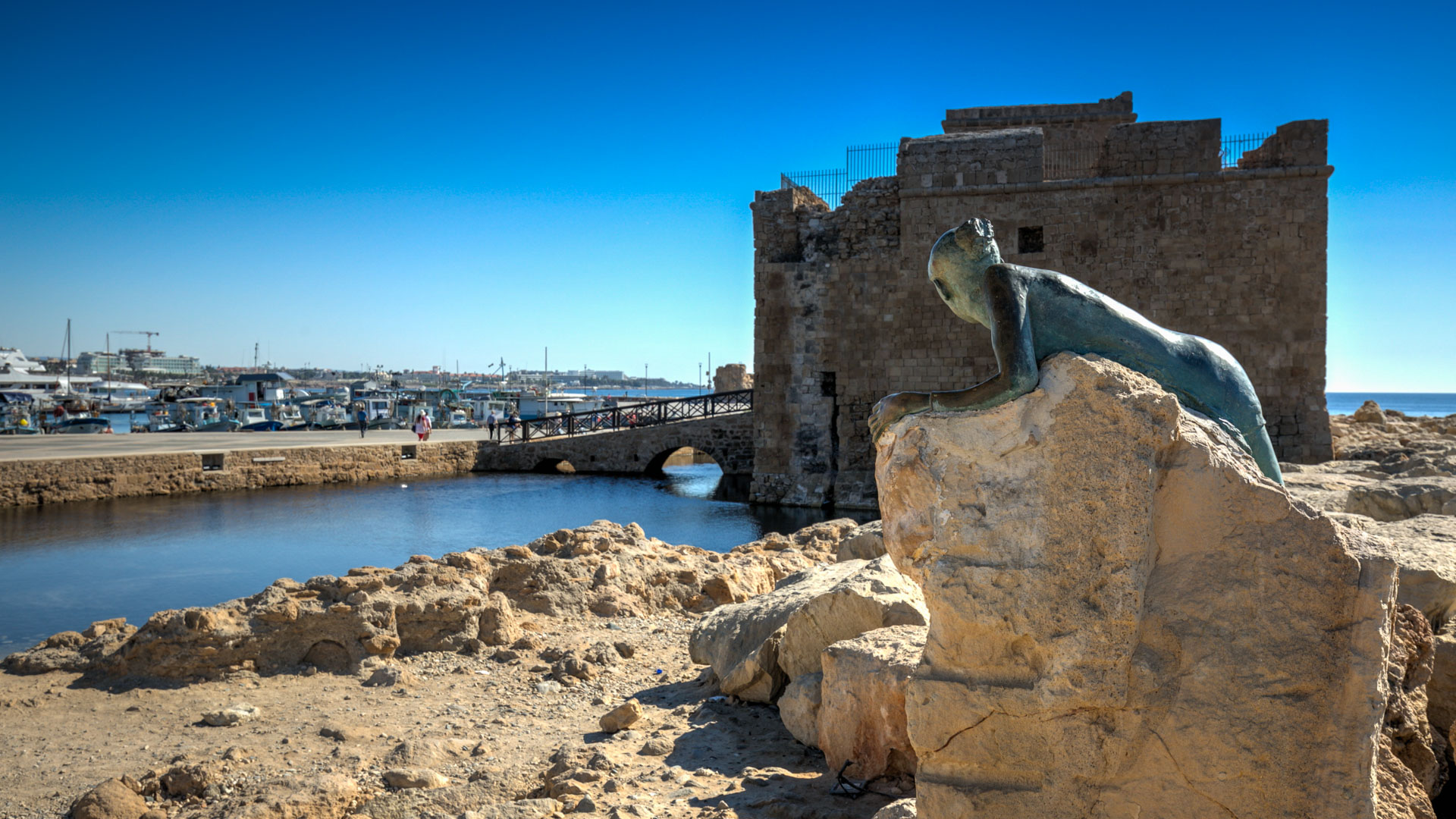 Paphos Medieval Fort, with Paphos harbour and little fishing boats in the background.